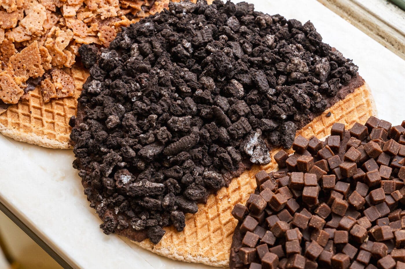 Melly's stroopwafels dipped in chocolate and finished with toppings