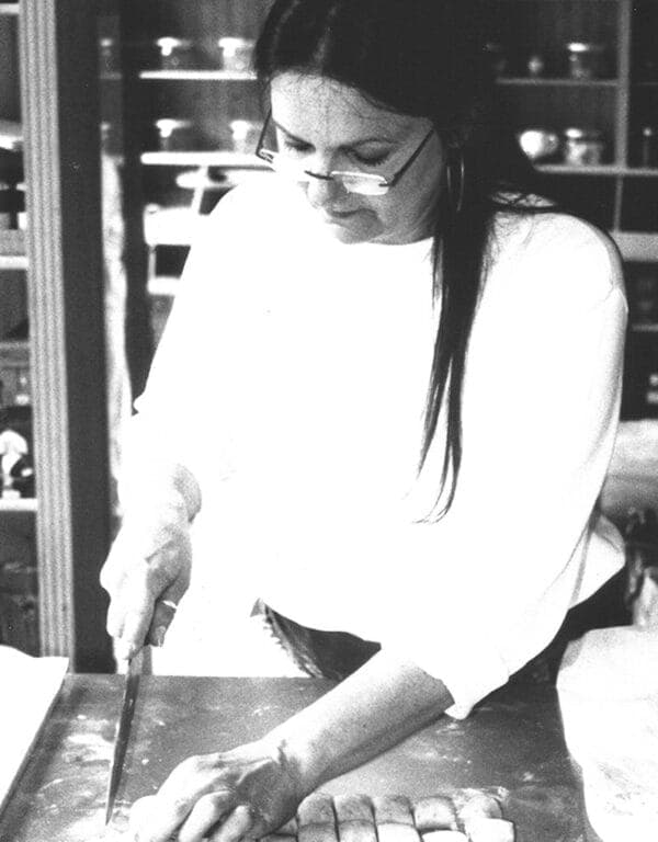 Rita Mellicovsky shaping pastries by hand in the kitchen